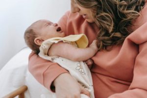 How do I stop my baby from vomiting after feeding